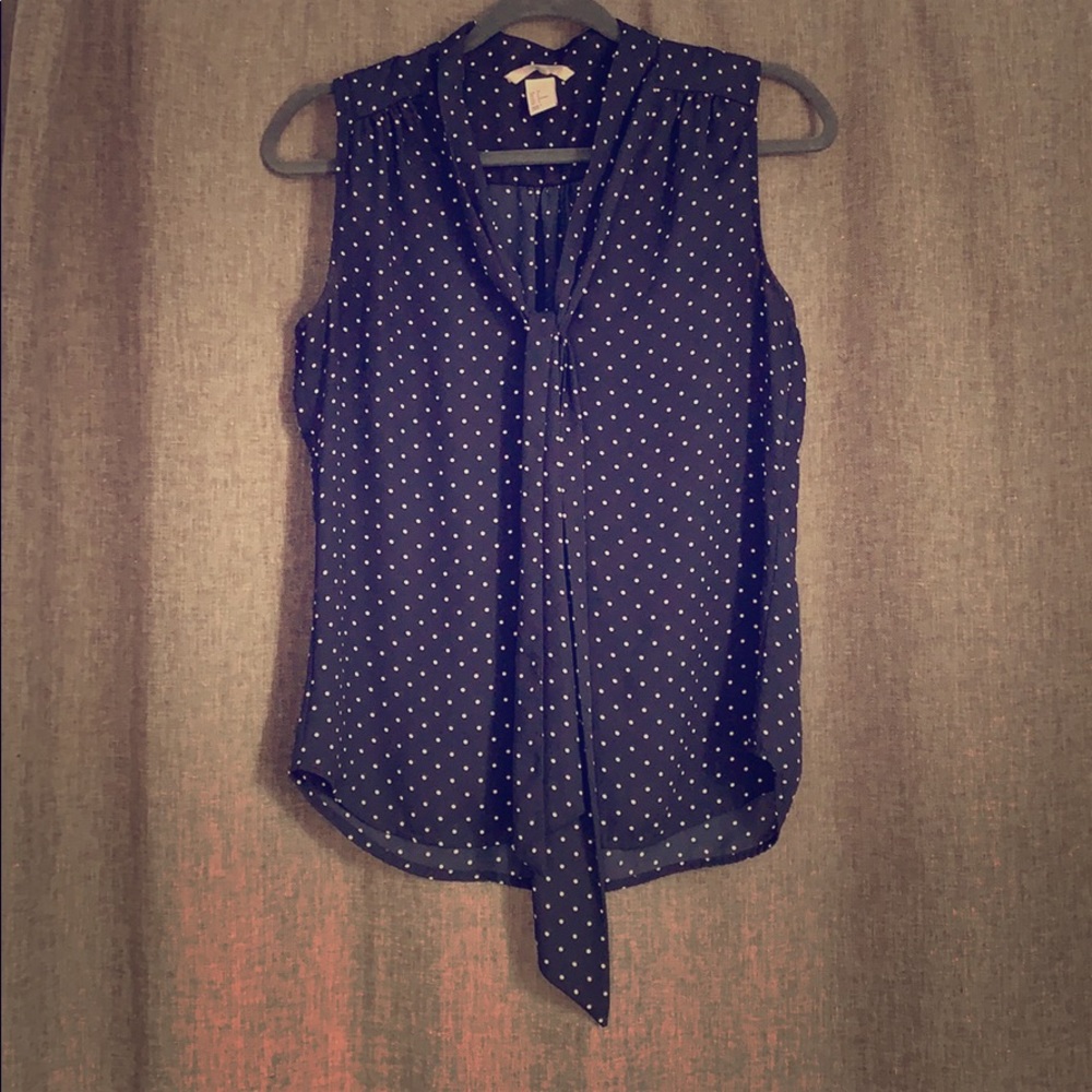 Navy and white sleeveless polka dot blouse